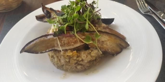 Bulgur wheat dish, topped with hummus and slices of grilled aubergine