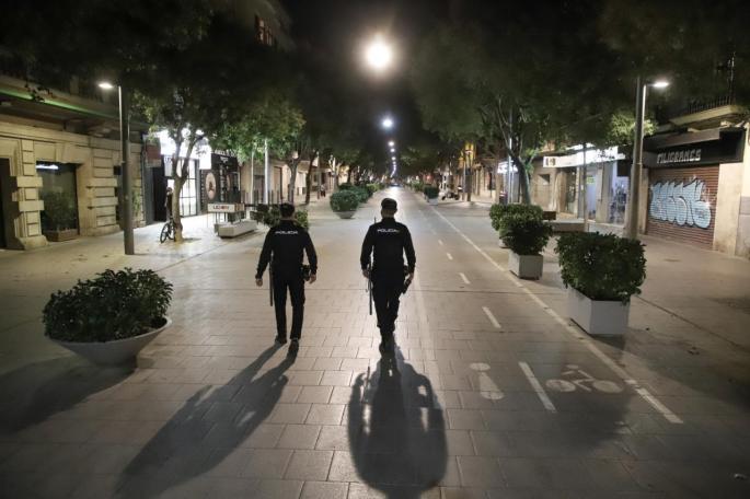 Police patrol in Mallorca, as curfew starts.