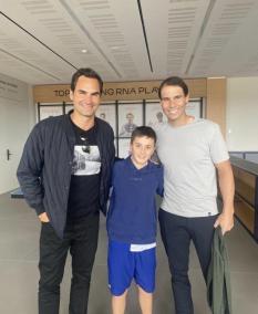 Roger Federer and Rafael Nadal with a young fan at the academy in Mallorca