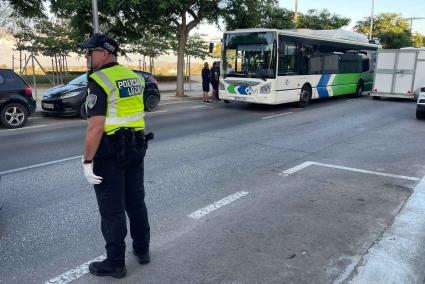 A local Police officer in Palma directs traffic in front of a bus in Palma