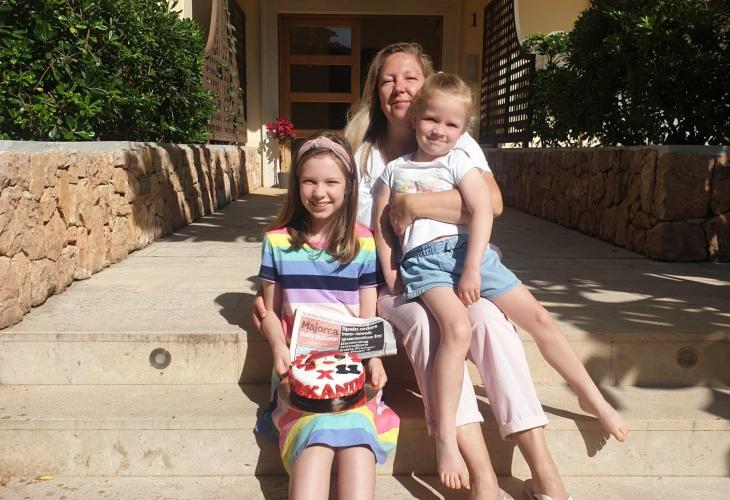 A very happy Alexandra with her mum and little sister.