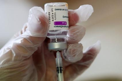 Medical worker prepares a dose of AstraZeneca COVID-19 vaccine at a vaccination center in Ronquieres