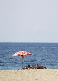 People sunbathe in Magalluf beach in Mallorca