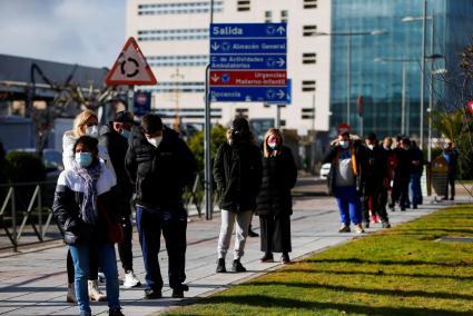 People queue to get tested for the coronavirus disease (COVID-19) after the Christmas holiday break, amid the COVID-19 pandemic, at Doce de Octubre Hospital in Madrid