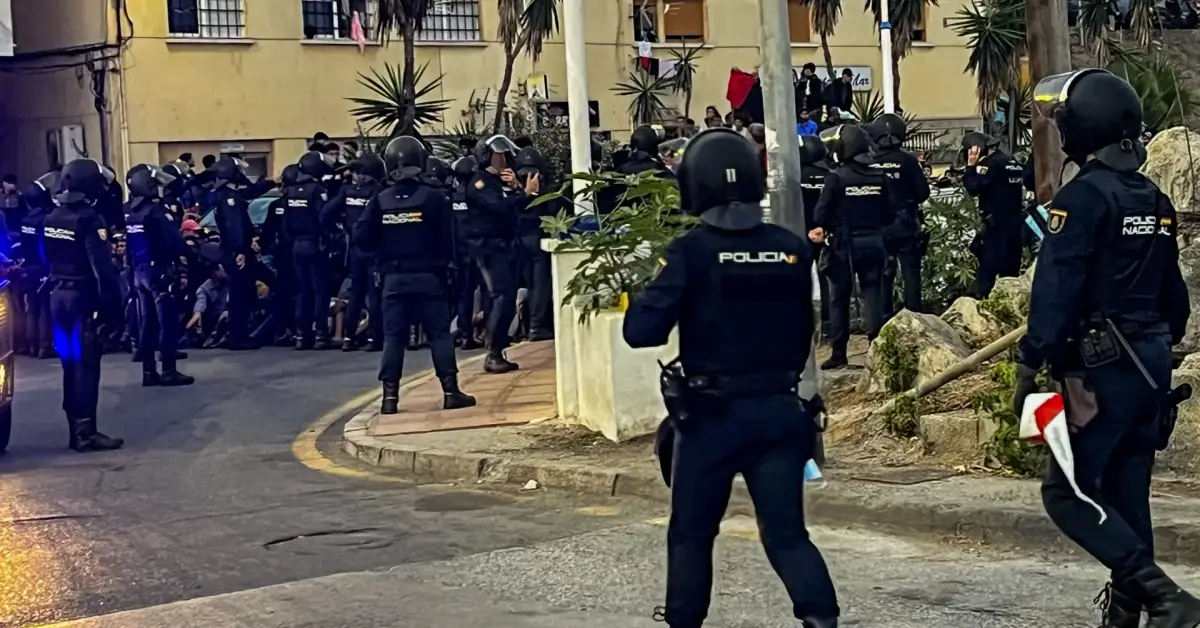 Spanish police fire rubber bullets as they attempt to clear migrants from the beach